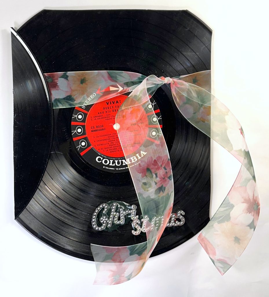 Bell and Ganassi Fidelity, 2025-26 Broken record, ribbon, and plastic letters on cardboard 12 x 8.5 inches